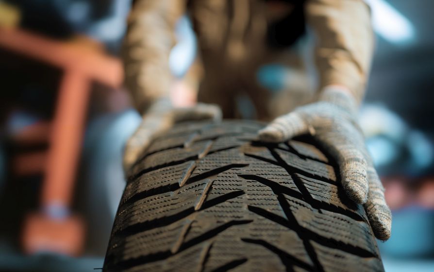 auto king inspects worn tyre tread for safer uk driving